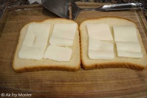 Add the butter to the inside of the bread slices.