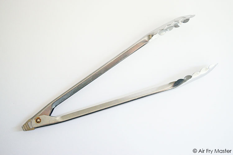 A single, aluminum tong on a white background.