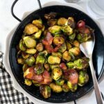 Air fryer brussels sprouts with bacon in a serving dish.