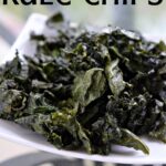 Air Fryer Kale Chips sitting on a white plate.