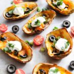 Air Fryer Potato Skins on a white marble surface.