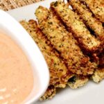 Air Fryer Zucchini Fries served with dip on a white platter.