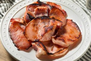 Air fryer Canadian bacon on a white plate.