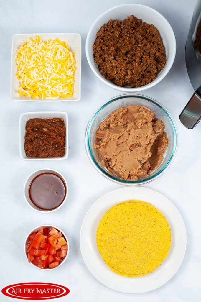 All the ingredients for this Air Fryer Copycat Taco Bell Mexican Pizza Recipe in individual bowls, sitting in two rows.