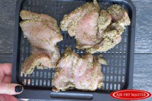 The Air Fryer Ranch Chicken Thighs spread out over the air fryer tray.