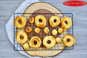 Browned donuts on a cooling rack.