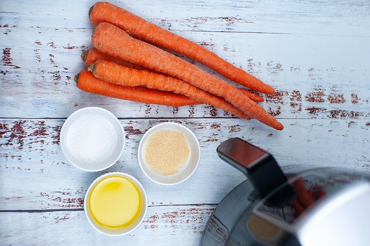 Air Fryer Carrot Fries Recipe ingredients on a white surface.