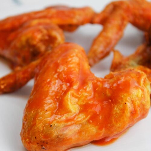 A close up of Air Fryer Chicken Wings on a white platter.