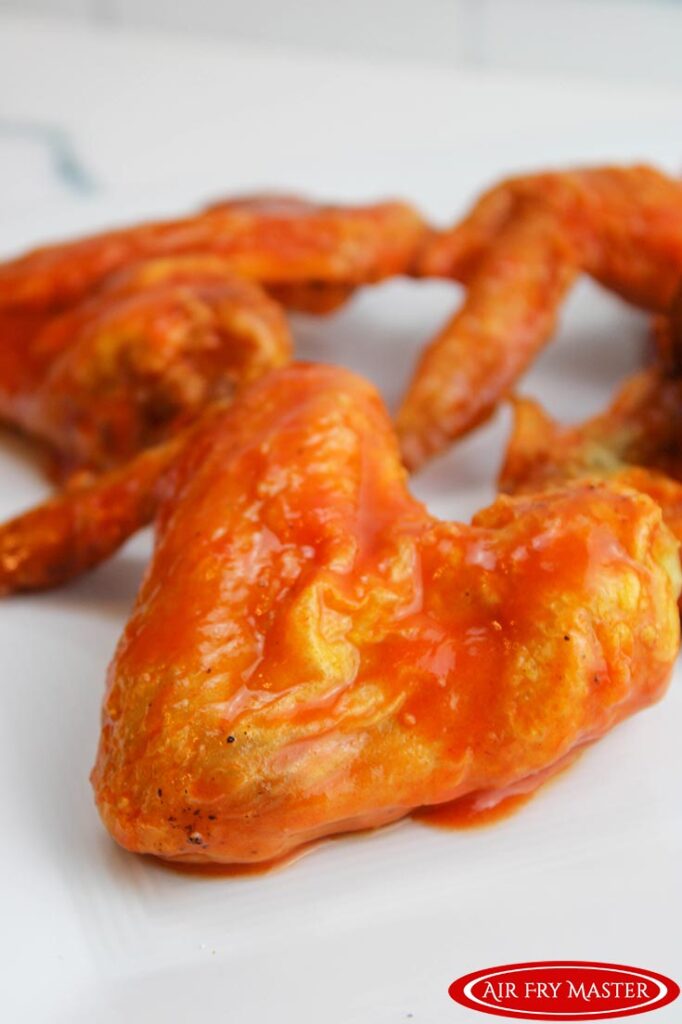 A close up of Air Fryer Chicken Wings on a white platter.