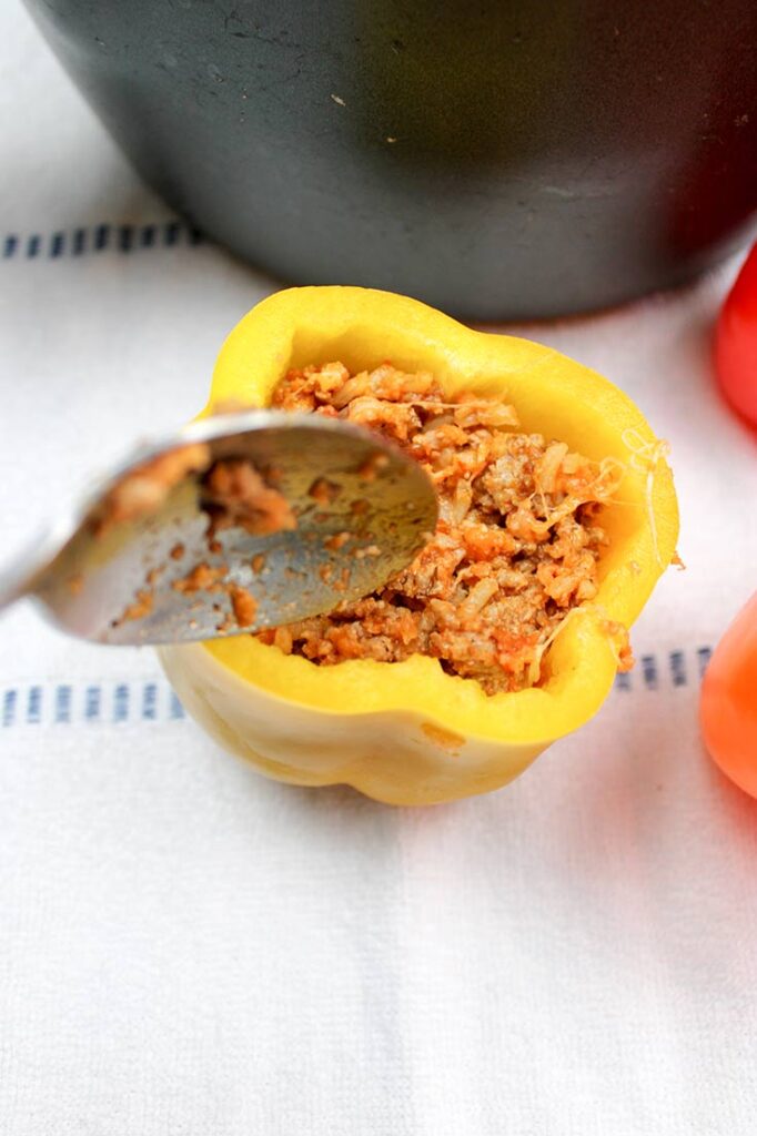 Ground turkey mixture stuffed into a cut and cored, yellow bell pepper.